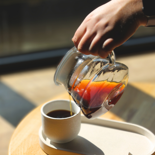 An image of someone pouring coffee