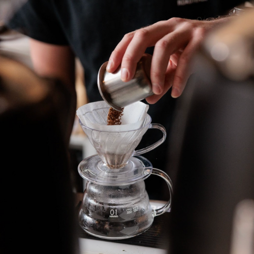 An image of a man using a V60 coffee maker